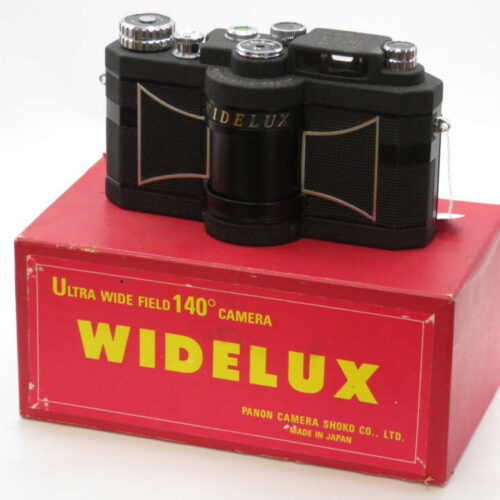 A vintage Widelux panoramic camera placed on top of its red box with yellow text detailing its features.