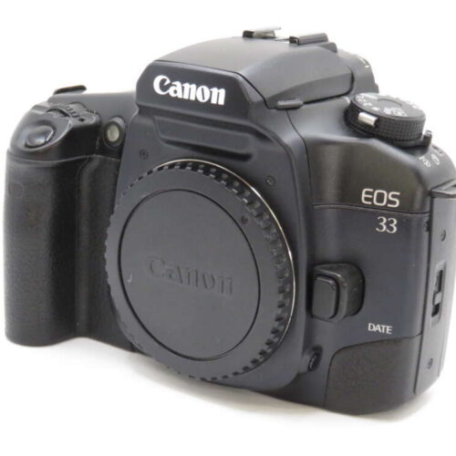 A Canon EOS 33 camera body with a lens cap, featuring dial controls and a textured grip.