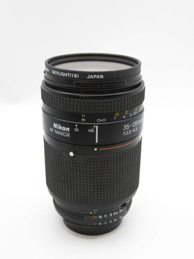 IMG_4185 A Nikon AF Nikkor 35-135mm camera lens with a Skylight filter attached, showing its focal range markings.
