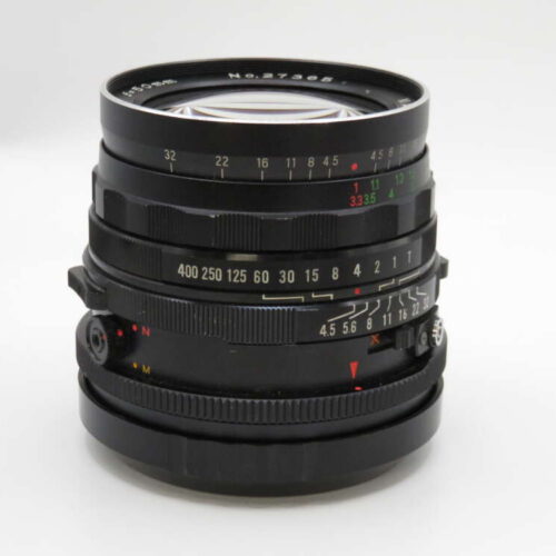 A black camera lens with various focus and aperture markings, shown on a plain white background.