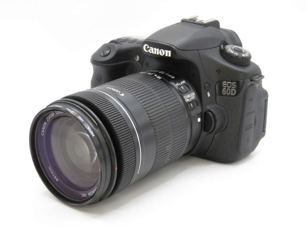 IMG_4200 A Canon EOS 60D DSLR camera with a zoom lens attached, viewed from the front-left angle.