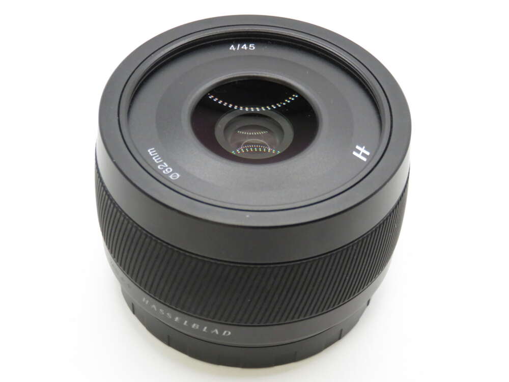 IMG_4225 A black Hasselblad camera lens with "62mm" and "45" markings on the front element.