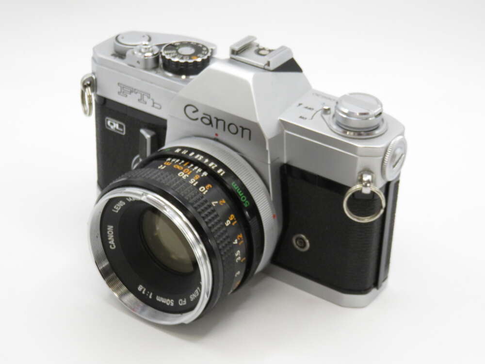 IMG_4258 A vintage Canon FTb QL film camera with a silver and black body and a Canon FD 50mm lens attached.