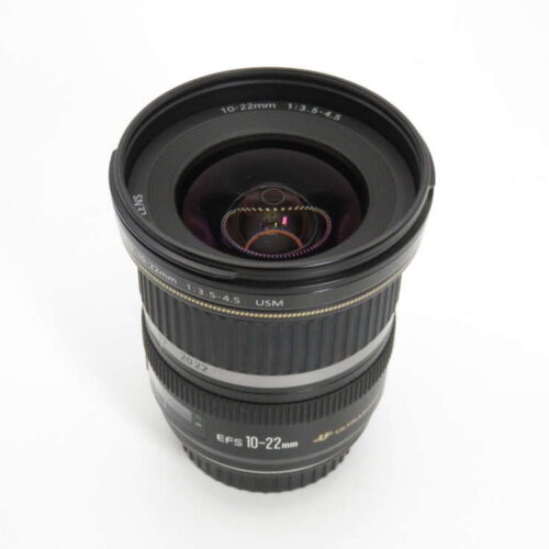 A wide-angle zoom camera lens with visible focal length markings of 10-22mm, featuring a prominent front glass element.