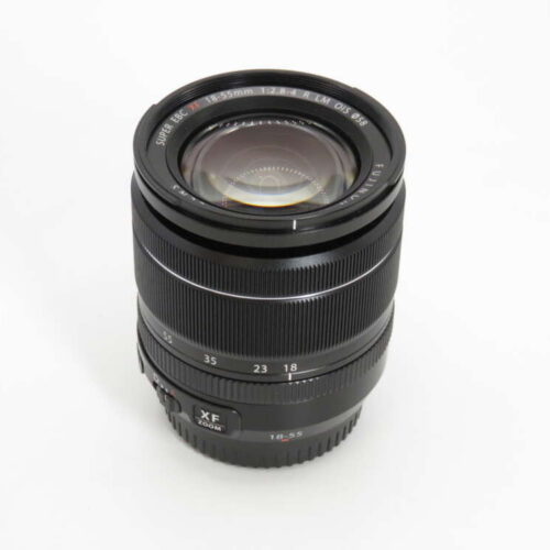 A black Fuji camera lens with focal range markings and an aperture ring, set against a plain white background.