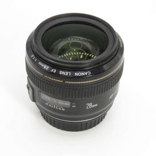 Black Canon 28mm camera lens on a white background, showing its focal length markings.