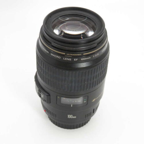 A Canon EF 100mm f/2.8 macro lens with a focus adjustment ring and distance indicator.
