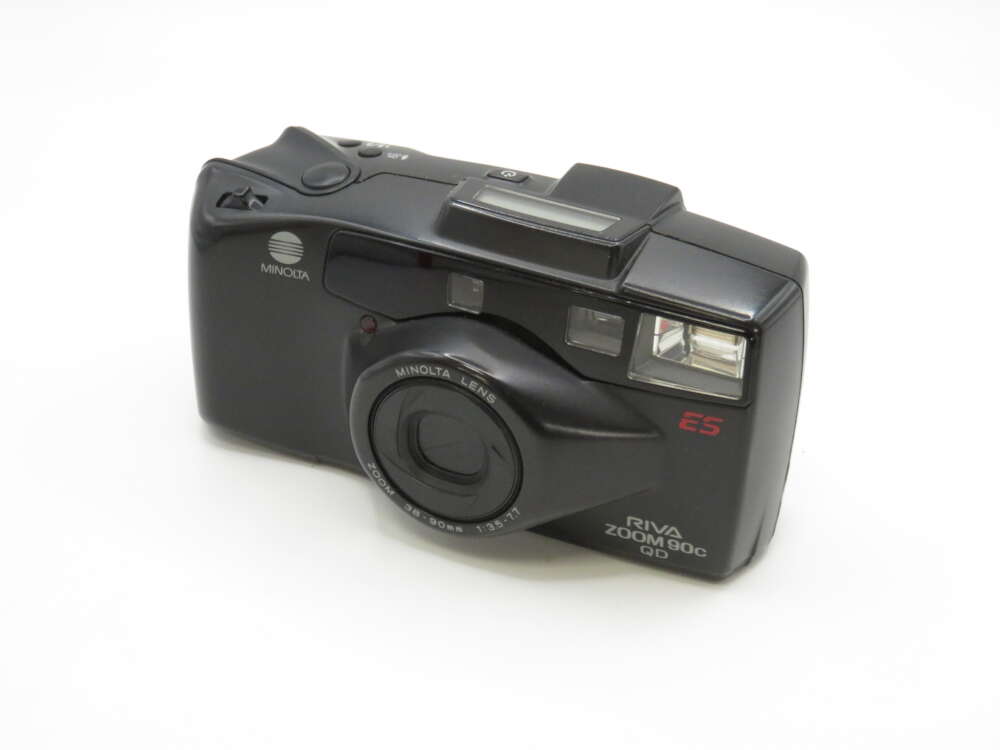 IMG_4285 A black Minolta Riva Zoom 90c film camera with a built-in flash and lens zoom ring.