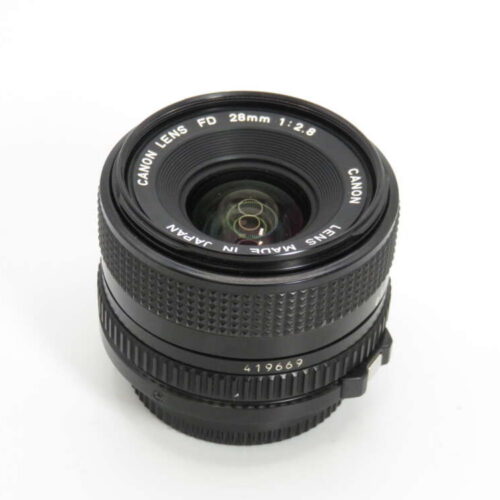 A Canon FD 28mm f/2.8 camera lens with visible text "Lens Made in Japan" and a textured focus ring.