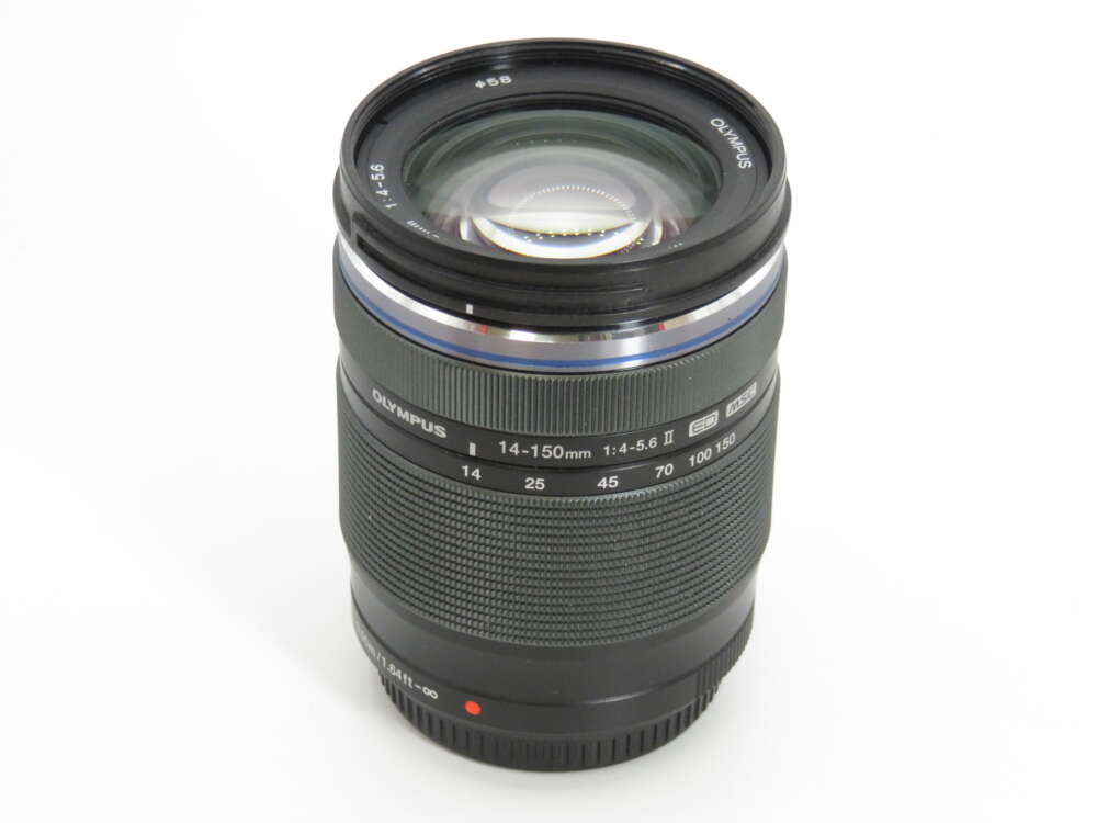 IMG_4324 A black Olympus 14-150mm f4-5.6 camera lens with visible zoom markings and ribbed grip.