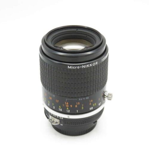 A Micro-NIKKOR 105mm camera lens with focus and aperture markings on a white background.
